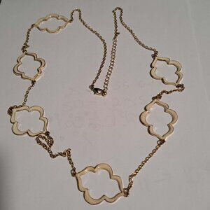 gold and cream colored long necklace